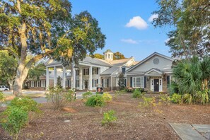 A large, multi-story building with a symmetrical facade, featuring a central entrance with columns, a bell tower, and a mix of brick and stucco exteriors. - Spacious 3 Bed + Bonus TH on the 12th Fairway at Pawleys Plantation Golf Course (Pawleys Island)