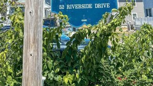 A sign for Admiral's Quarters at 52 Riverside Drive. - Admiral's Quarters (Wells)