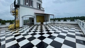 A building with a checkered floor and a spiral staircase.