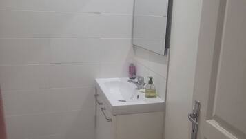 Een haardroger, handdoeken, zeep, toiletpapier