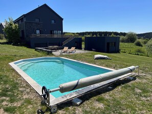 A swimming pool with a cover, a house, and a grassy yard. - Enjoyable 3-bedroom house with Saun in Belgian Ardenne for your getaway (Fauvillers)