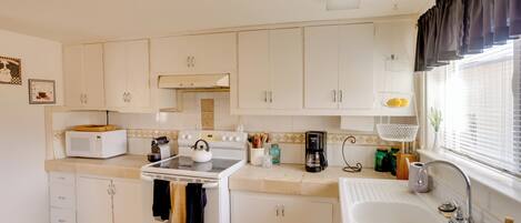 Fridge, microwave, stovetop, coffee/tea maker