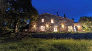 A stone building with multiple windows and doors, surrounded by trees and a grassy area. - Pieve Vecchia - Charming and modern villa in Tuscany (Toscana)