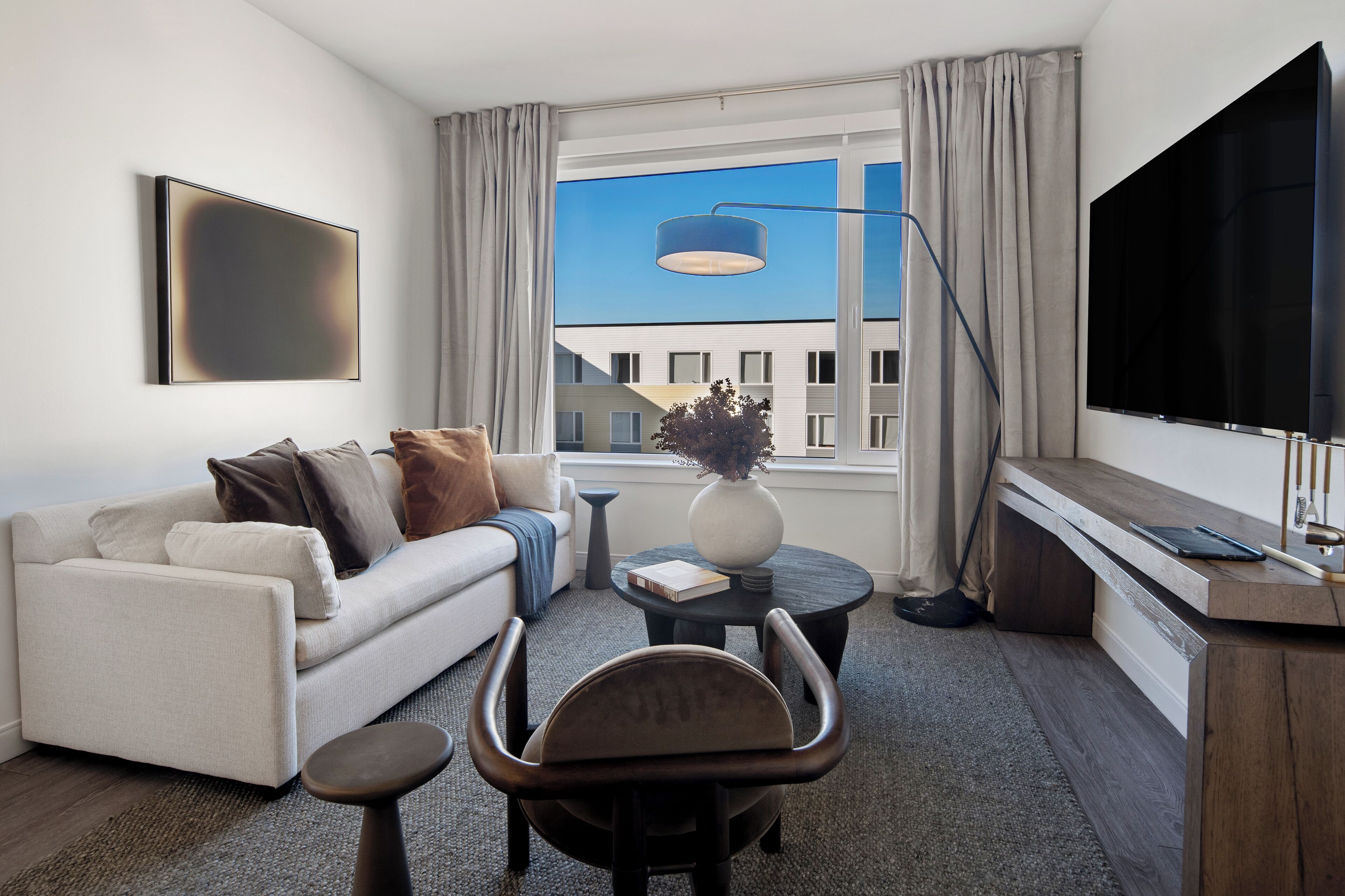 A modern living room with a sofa, coffee table, and a TV.