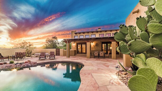 A pool area with a clear view of the sky and a building with a flat roof and multiple windows. - Private, Peaceful, and Spacious Desert Tucson Villa with Heated Pool and Hot Tub (Tucson)