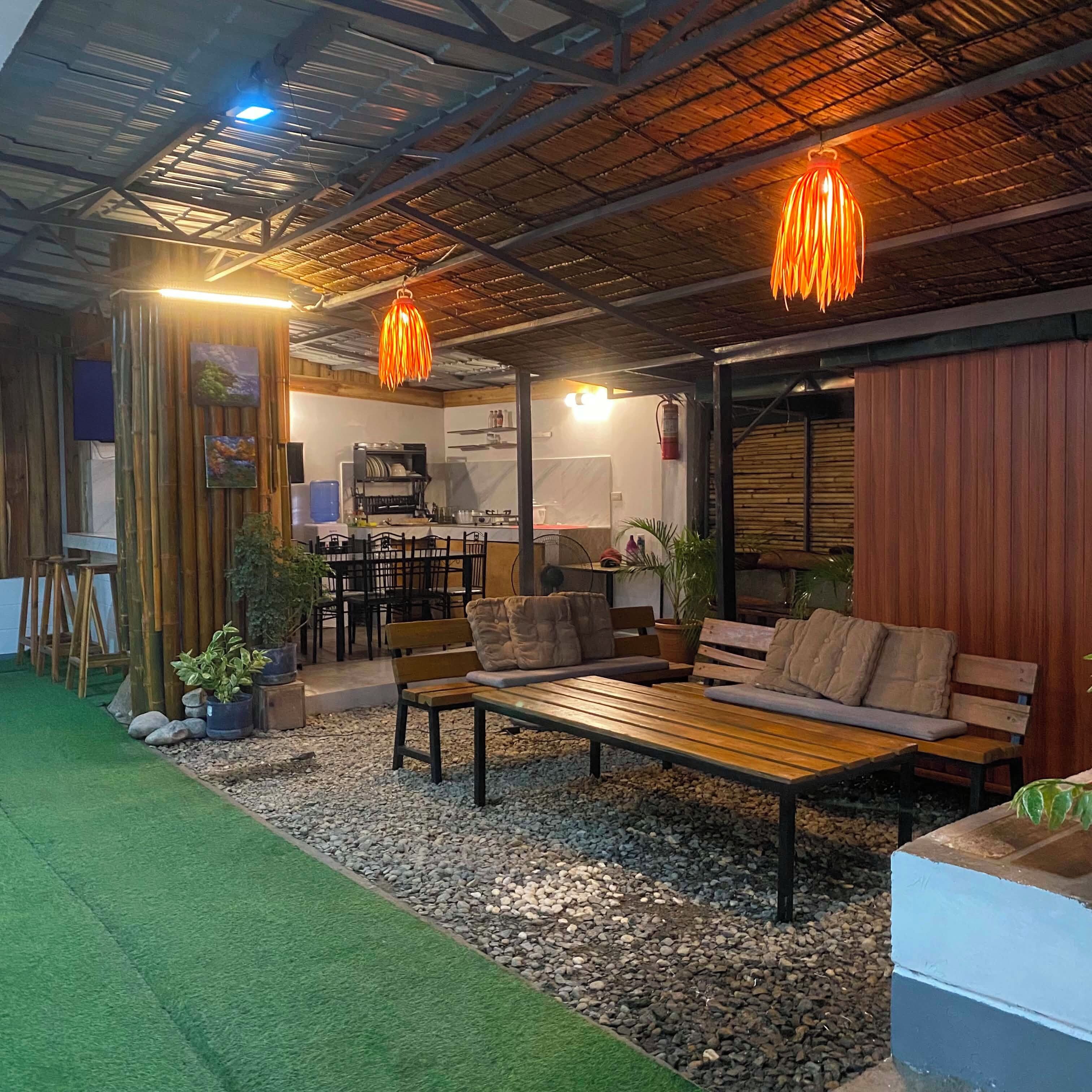 An indoor space with a seating area, a kitchen, and a dining area.