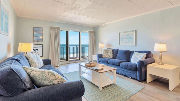 A living room with two sofas, a coffee table, and a side table with lamps. - Ocean Hideaway 508 (Ocean City)