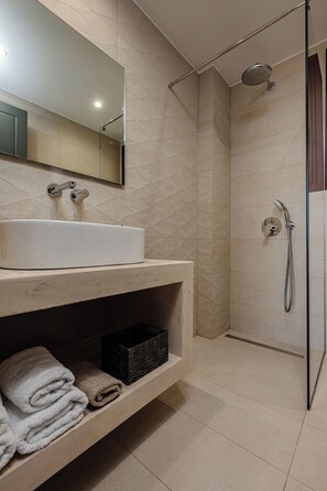 A modern bathroom with a large sink, a mirror, a shower, and a shelf with towels. - Your Private Oasis in Zakynthos, Pool & Sea Views - Adelda Villa (Kipsel)