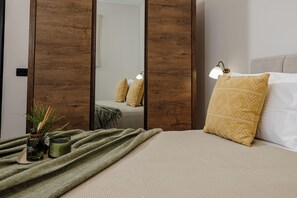 A neatly arranged bedroom with a bed, pillows, a bedside lamp, and a mirror. - Your Private Oasis in Zakynthos, Pool & Sea Views - Adelda Villa (Kipsel)
