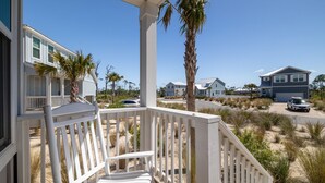 A beachfront property with a porch, white railings, and a view of neighboring houses and beach. - Heated Salt Pool | Walk to Beach | Lowered Rates | Firepit (Port St. Joe)