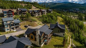 A residential area with multiple houses, some with balconies, surrounded by trees and hills. - Rendezvous 4BR Retreat | New Hot Tub, Mtn Views (Winter Park)