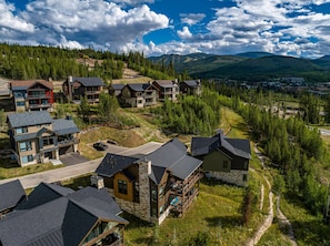 A residential area with multiple houses, some with balconies, surrounded by trees and hills. - Rendezvous 4BR Retreat | New Hot Tub, Mtn Views (Winter Park)