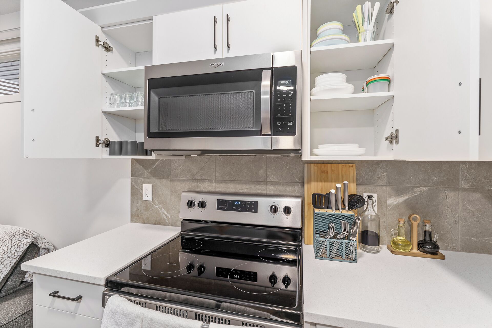 A modern kitchen with a built-in microwave, oven, and stovetop.