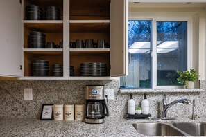 A kitchen with granite countertops, a coffee maker, and a sink. - Kaweah Oaks Cabin: Firepit, Hot Tub, Game Room (Three Rivers)