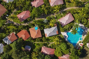 An aerial view of a resort with multiple buildings, a swimming pool, and lush greenery. - BBQ•Pool•Garden•Smart TV•Parking•A/C•King Bed•W/D – Villaggio 376 (Potrero)