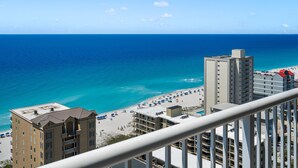 A high-rise hotel with balconies overlooking a beach, clear blue sea, and sunny weather. - 18th Floor!  Indoor/Outdoor Pools. Free Daily Activities + Beach Service (Gulf Shores)