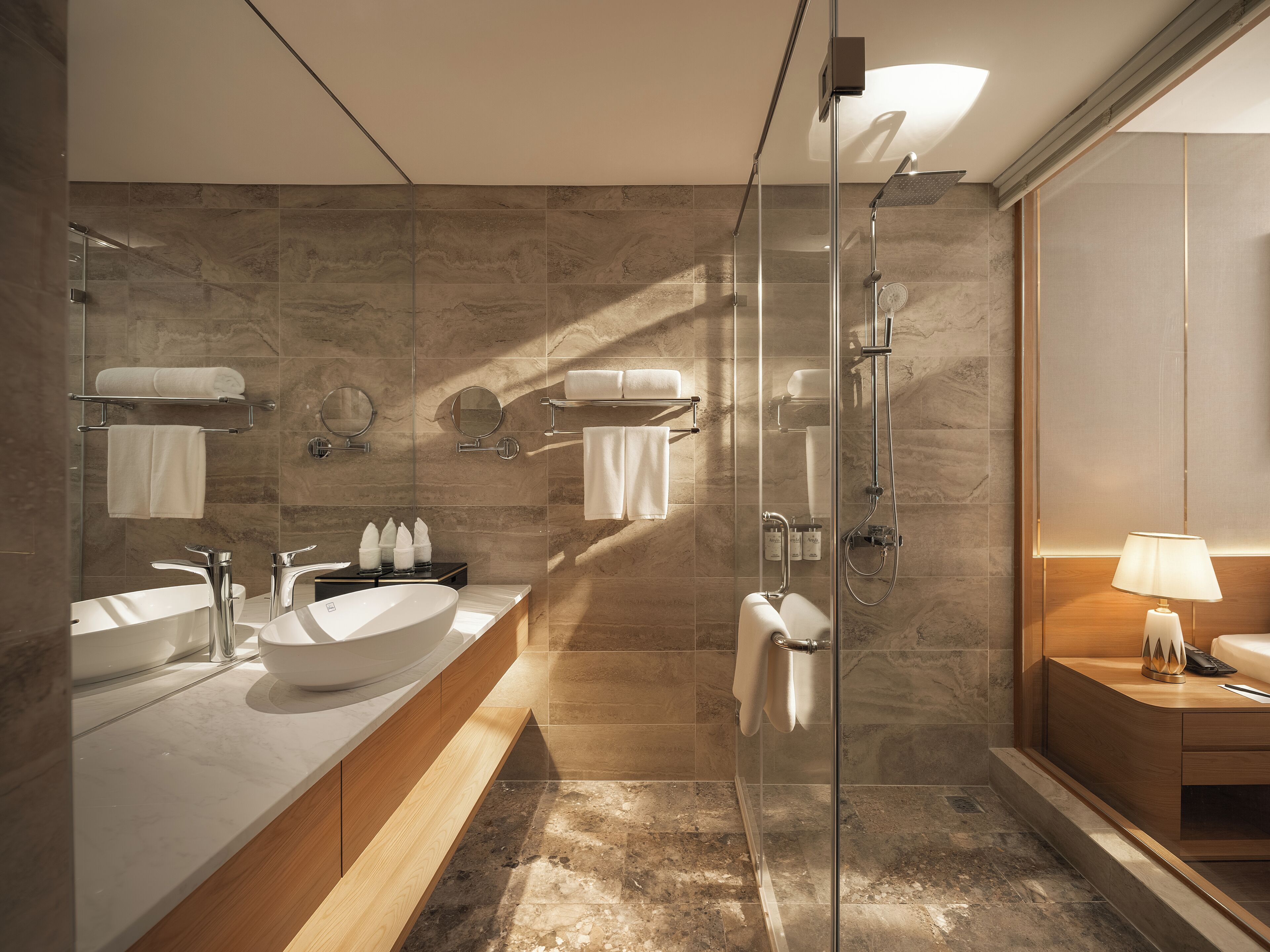 A modern bathroom with a glass-enclosed shower, a vanity with a large sink, and a wooden cabinet.