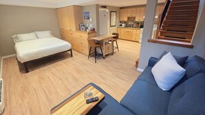 A compact living space with a bed, sofa, dining table, and kitchenette. - Amazingly convenient central location in Rossland with everything you need! (Rossland)