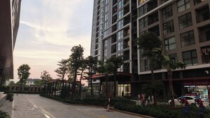 Un immeuble moderne à plusieurs étages, doté de grandes fenêtres et de balcons.