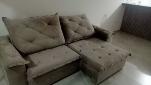 A sectional sofa with a chaise, two large cushions, and a small ottoman. - Paradise Family House - your beach house! (Tamoios)