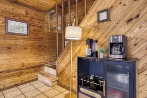 A wooden interior with a staircase, a coffee machine, and a framed map on the wall. - Panoramic Views•Games•HotTub •Theater•Golf•3 Pools (Gatlinburg)