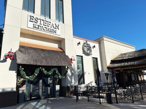 A building with a sign reading "ESTEFAN KITCHEN" and a wreath above the entrance. - Margaritaville Luxe Cottage • 2 Master Suites • Disney ~5m • Walk to Fun & Eats (Kissimmee)