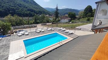 Seasonal outdoor pool, open 10:00 AM to 9:30 PM, pool loungers