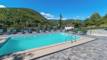 Seasonal outdoor pool, open 10:00 AM to 9:30 PM, pool loungers