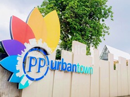 A sign with the text "PP Urban Town" and a colorful logo.