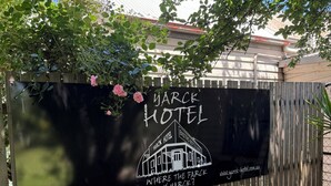 A sign for Yark Hotel with a rustic design, including a building illustration and the hotel's website URL. - Yarck hotel  (Yarck)