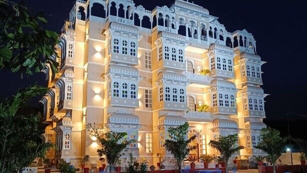 A multi-story building with traditional architecture, featuring balconies and arched windows. - Aryavarta A boutique abode (Udaipur)