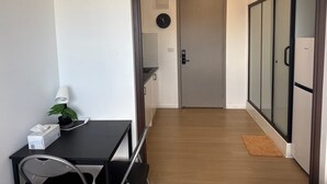 A modern room with a desk, chair, lamp, potted plant, and a sliding door leading to another room. - Metawise Peaceful Home Close to Monash Uni and Chadstone U2 (Melbourne)