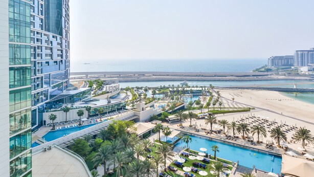 A high-rise hotel with a pool area, beach view, and multiple amenities. - Al Bateen Ultra Luxe 5BR I Private Beach (Dubai)