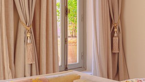 A room with a window, curtains, and a bed with patterned pillows. - Kasbah La Moun The Art of Hospitality (Marrakech)