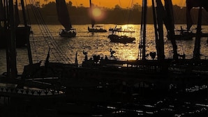 A sunset over a harbor with multiple sailboats. - Charming deluxe villa, family atmosphere in the authentic West Bank of Luxor (Luxor Governorate)
