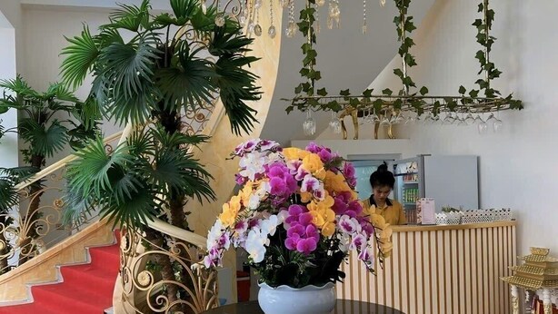 A lobby with a grand staircase, a reception desk, and a chandelier. - RUBY HOTEL FRONT OF BEACH 2 (Tien Thanh)