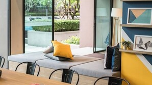 A modern meeting room with a long table, chairs, and a sofa with cushions. - Valley Mountain View&City Proximity
 1 bedroom 1 living room 1kitchen 1 toilet (Phuket)