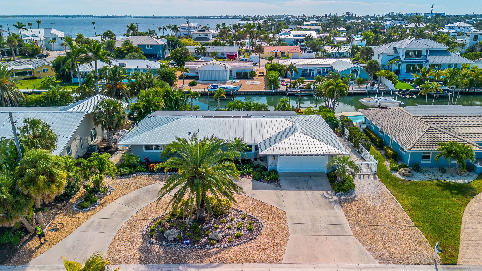 A residential area with houses, a swimming pool, and a marina.