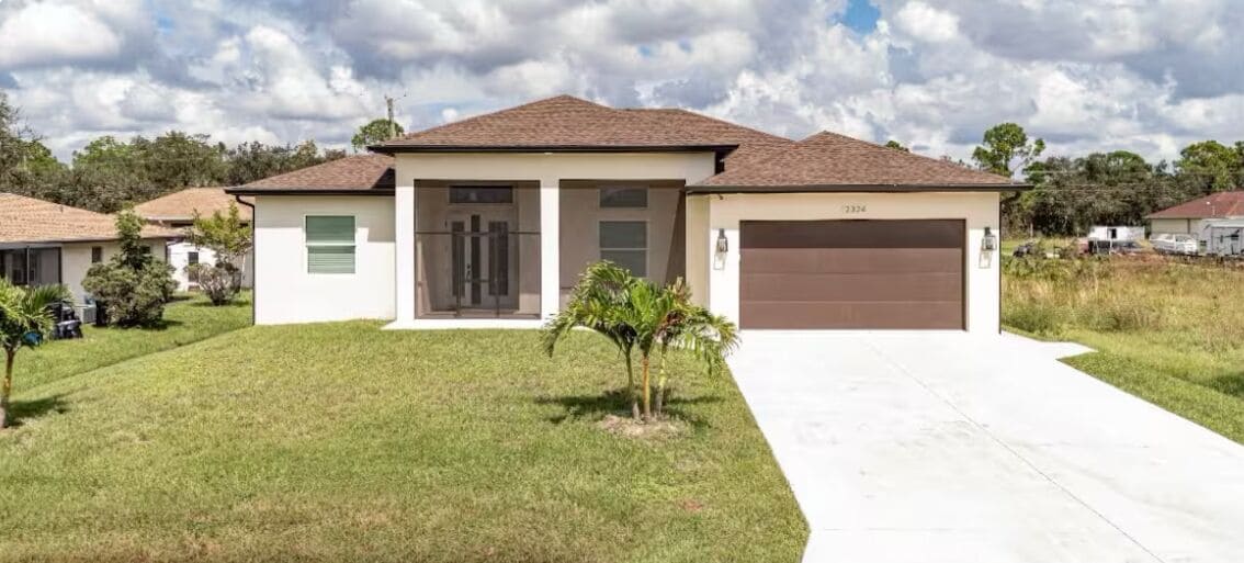 A single-story house with a brown roof, beige walls, and a front garage.