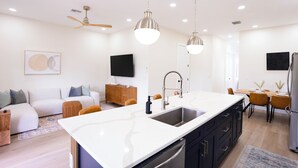 A modern kitchen with a large island, built-in appliances, and pendant lighting. - Luxury Retreat in Reunion w/Private Pool and Hot Tub - Sleeps 10 (Kissimmee)