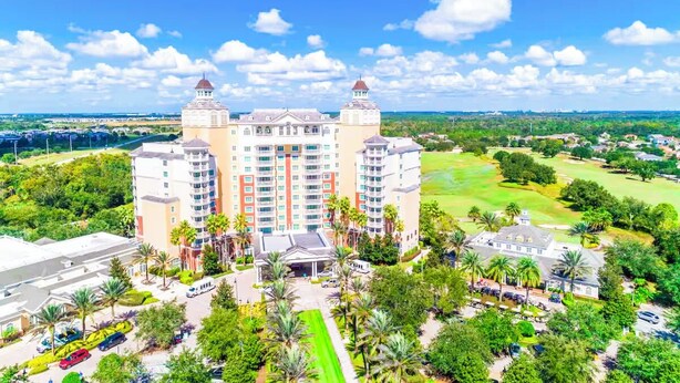 A large hotel with multiple towers, a central entrance, and surrounding greenery. - Luxury Retreat in Reunion w/Private Pool and Hot Tub - Sleeps 10 (Kissimmee)