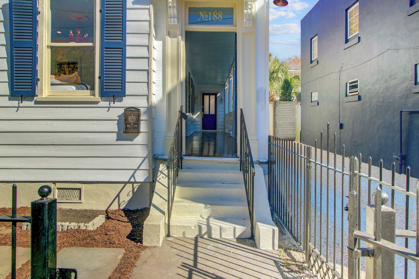 A two-story building with a visible mailbox and a door with a sign above it.