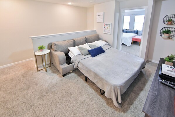 A bedroom with a bed, a small seating area, a round table, and a desk with a computer. - Disney Home w/Private Pool - Resort Fun Sleeps 10 (Kissimmee)