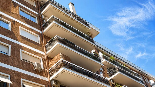 A multi-story residential building with balconies, brick facade, and large windows. - ANTONIO APARTMENT IN ROME (Roma)