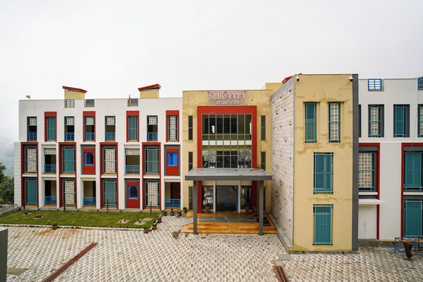 A multi-story building with a sign that reads "SUKAMA RESORT & SPA". - Sukama Resort & Spa (Dhari)