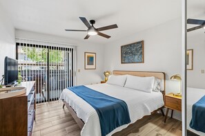 A bedroom with a bed, bedside tables, a desk, a ceiling fan, and a window with blinds. - 2-BD 2-BA condo in the fantastic Catalina Foothills, 2 pools & fitness Ctr gated (Tucson)