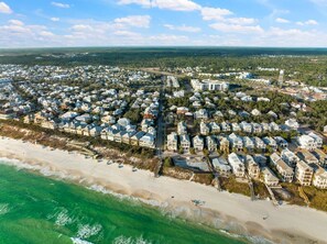 An aerial view of a coastal residential area with houses, a beach, and a water tower. - Private Pool, Walk 2 Rosemary & Beach, Sleeps 10 (Inlet Beach)