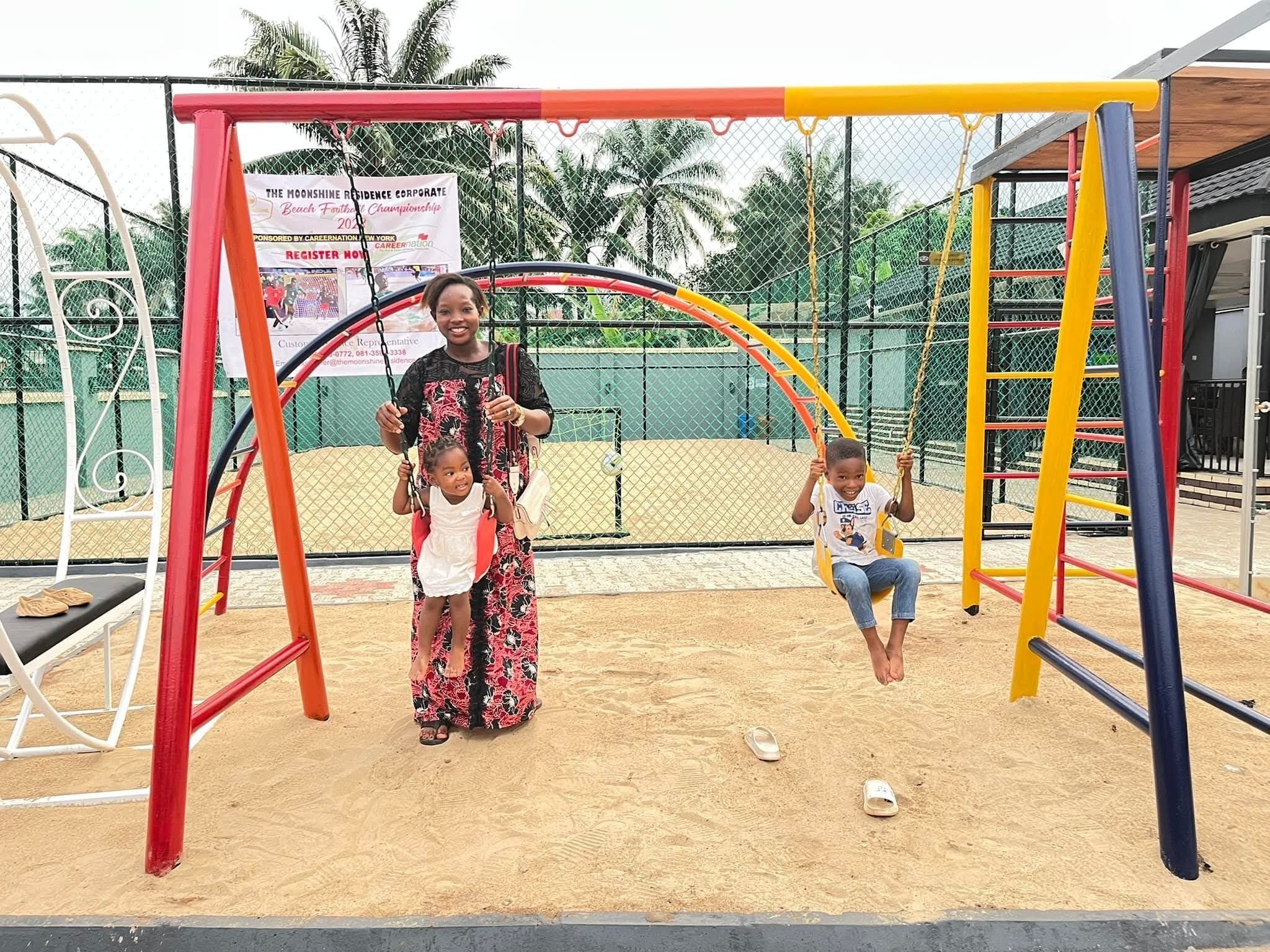 A playground with swings and a sandpit.