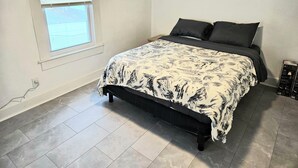 A bedroom with a bed, a window, and a thermostat. - Apartment located in vibrant Montclair 2-blocks to NYC trains (Montclair)