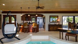 A spacious indoor pool area with a dining area, kitchen, and seating. - Enjoy the life at Villa Adagio, St John, Chocolate Hole in t (Cruz Bay)